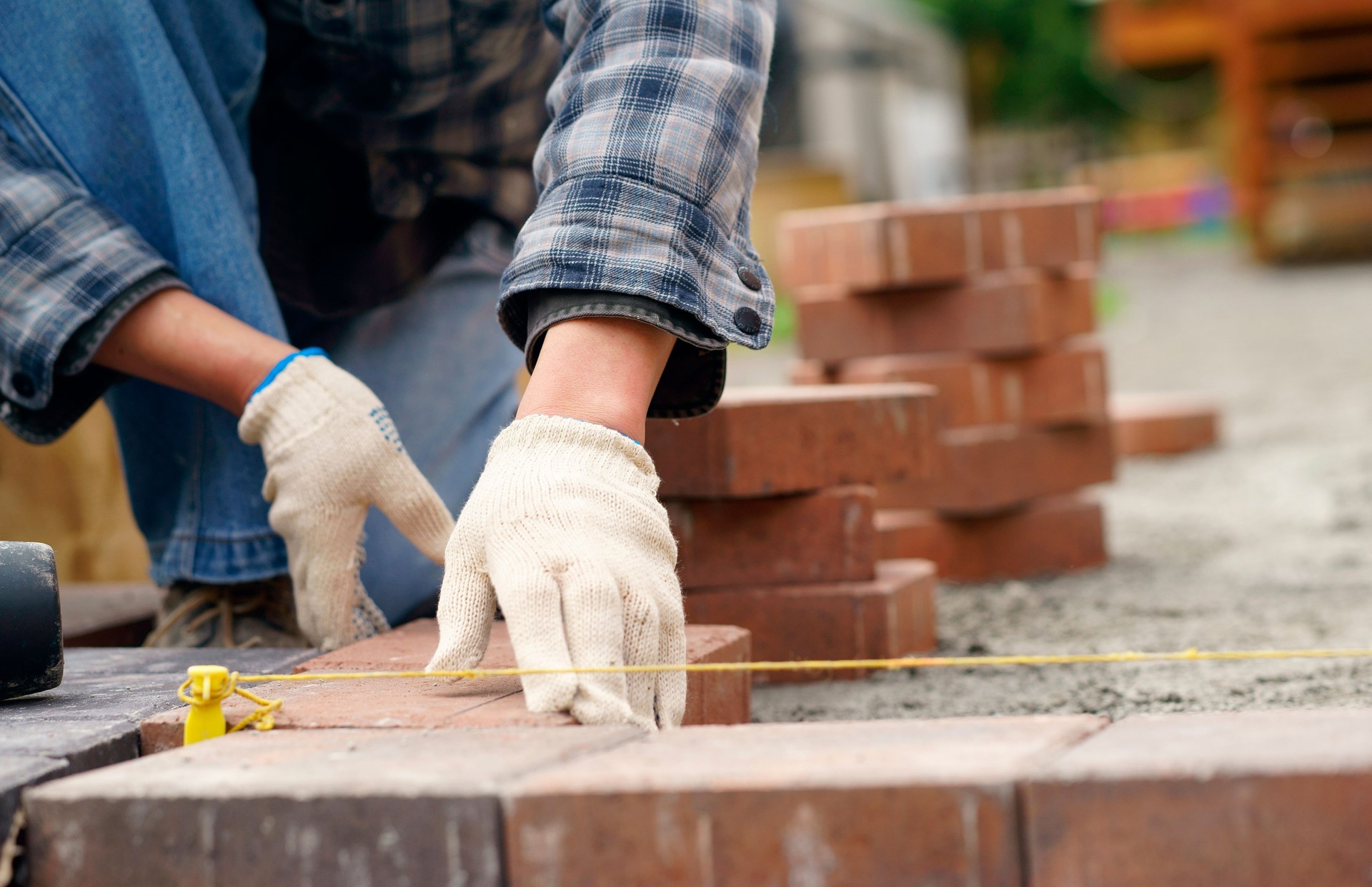 Laying gray concrete paving slabs in house and tools