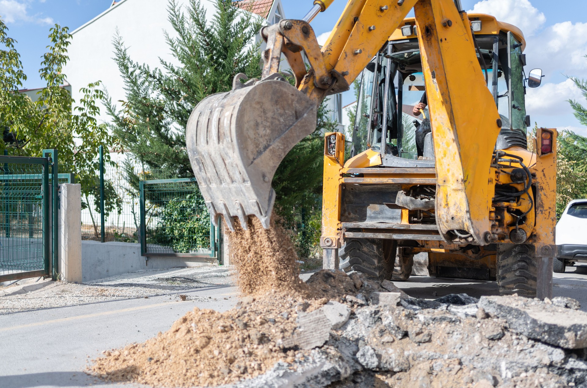 Excavator Digging Asphalt On The City Street